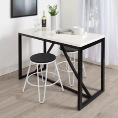 a table with two stools next to it