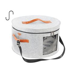 a grey and orange storage box with an umbrella hook on the top, hanging from a black cord