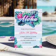 an aloha birthday party is set up by the pool with flowers and palm leaves