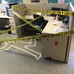 an office cubicle with caution tape around it