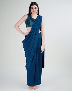 Stitched Saree with blouse in Teal blue colour KAT201 A full-stitch drape saree is a contemporary take on the traditional Indian saree, combining the elegance of the drape with the convenience of a pre-stitched garment. This innovative design features a pre-pleated pallu and a stitched skirt, offering ease of wear without compromising on style. Ideal for modern women who appreciate the grace of a saree but seek practicality in their attire, the full-stitch drape saree allows for effortless drapi Pleated Saree, Sequin Saree, Salwar Dress, Teal Blue Color, Wedding Saree Collection, Dress Salwar Kameez, Readymade Saree, Ready To Wear Saree, Lehenga Style