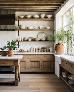 a kitchen filled with lots of wooden cabinets and counter top space next to a window