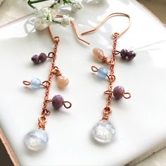 Rose gold tone long dangle earrings with beautiful white rainbow moonstone, Feldspar raw stone beads, as well as other beads in different colors.  These handmade elegant long boho chic style earrings are fun to wear. If you are looking for something unique and colorful for birthday or Valentine's Day gift, these earrings are for you! They are suitable for most occasions, whether for wearing for dates,  parties or beach walks.  Shipping & returns  FREE SHIPPING in the US   Ready to ship in 1-5 bu Earrings Boho Chic, Beach Walks, Dangle Earrings Boho, White Rainbow, Long Dangle Earrings, Moonstone Earrings, Colorful Earrings, Earrings Boho, Raw Stone