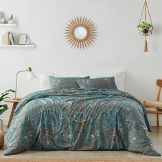 a bed in a room with a blue comforter and pillows