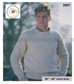 a man is wearing a sweater and standing with his hands in his pockets while looking at the camera