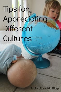 two toddlers playing with a globe on the floor and text overlay reads tips for appreciating different cultures