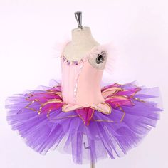 The perfect tutu for a dance recital! Elegant, shiny and multi-colored, this ballet costume is the perfect fit for any group dance or solo. The bodice is made with elasticated pink fabric, and features pink and lilac flower appliques around the neck, and pink sequins across the length of the bodice. The lilac tulle tutu skirt is the highlight of this costume, making the tutu look like a flower. In the top part of the tutu skirt, we have added hot pink organza inserts, decorated with gold trims. Fitted Tutu Dress With Attached Cancan For Costume Party, Princess Style Fitted Tutu Dress For Dance, Fitted Multicolor Tutu Dress With Tulle Skirt, Pink Tulle Tutu Dress For Costume Party, Pink Tulle Tutu Dress For Dance, Fitted Multicolor Tutu Dress For Costume Party, Fitted Tulle Tutu Dress For Dance, Fitted Tutu Dress For Costume Party And Carnival, Balletcore Tutu Dress For Party