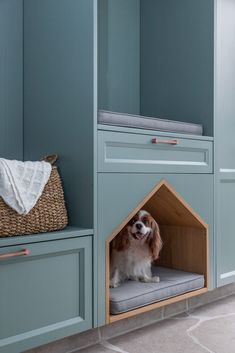 a dog is sitting in its kennel at the entrance to his house, which has been built into the wall