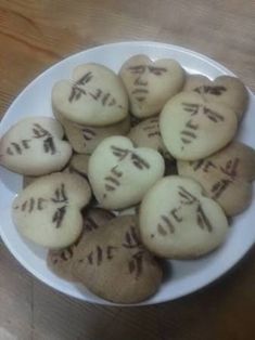 a white plate topped with cookies covered in writing