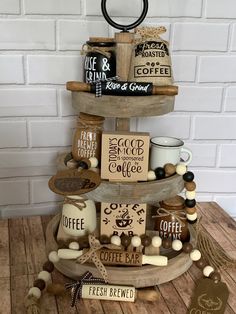 a three tiered tray with coffee mugs and other items on top of it