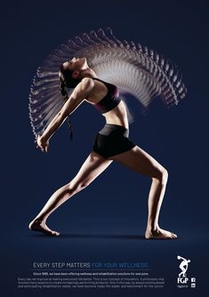 a woman is doing yoga with an angel wings above her head and arms behind her back