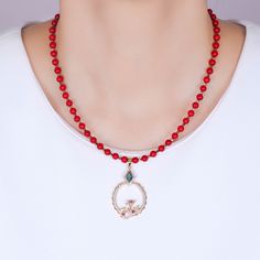 Doris Red Coral Gemstone Bead Necklace DESIGN DETAILS:This beautiful natural stone bead necklace is made with 5mm red coral gemstone beads. With an abstract coral reef design, the pendant features blue, ruby red, peridot green and white cubic zirconia crystals. There are 2 kinds of gold plating on the pendant. The necklace clasps are gold filled metal.PENDANT NECKLACE DETAILS:- PENDANT LENGTH: 1.75 inches | WIDTH: 1 inches- CHAIN LENGTH: 16 inches + 2 inches extension- CHAIN CLOSURE: Lobster Cla Red Beaded Pendant Necklace, Red Beaded Pendant Necklace With Natural Stones, Red Pendant Crystal Necklaces With Gemstone, Red Gemstone Pendant Crystal Necklaces, Red Crystal Pendant Necklaces, Red Crystal Pendant Necklace With Natural Stones, Red Gemstone Pendant Crystal Necklace, Red Natural Stone Crystal Pendant Necklace, Red Crystal Necklace With Gemstone Beads