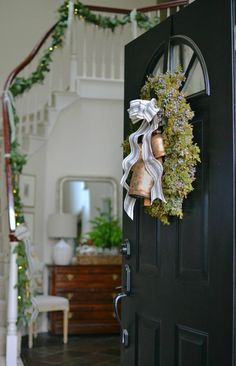 a door with a wreath and bells on it