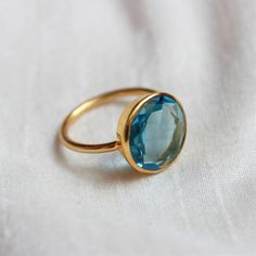 D E T A I L S - Material: Sterling silver 925 Stone: Blue Topaz Quartz (Lab Created) The fit: True to US ring size Finish: Smooth and Gold Plated to a high shine S H I P P I N G & P R O D U C T I O N - My current production time is 2-6 business days, which means after those days are up, your order ships! I make everything custom to order, by hand, but I promise you it's worth the wait! R U S H - M Y - O R D E R - If you're in a rush to get your pretty new pieces, please send me a message and Blue Topaz Ring With Round Band For Promise, Turquoise Topaz Ring, Blue Topaz Ring With Bezel Setting For Gift, Blue Topaz Ring With Bezel Setting As Gift, Blue Topaz Ring With Vs Clarity For Gift, Blue Topaz Round Band Ring, Blue Topaz Ring With Vs Clarity As Gift, Gift Topaz Ring With Vs Clarity, Blue Topaz Birthstone Ring With Round Band