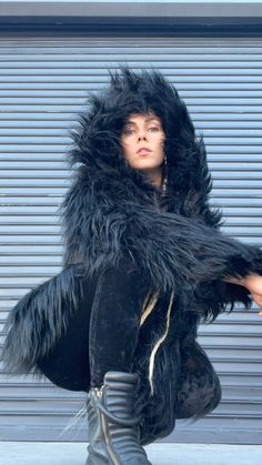 "Prowl the urban jungle with the \"Black Cat\" reversible faux fur coat, a sleek testament to nocturnal mystique and dual-natured design. 🌙✨ One of a kind and ready to ship in XS size only. ❖ Dual-Sided Drama: Luxurious black faux fur on one side, and an enchanting, patterned fabric on the other, offering two impactful looks. ❖ Night Prowler's Charm: Like the enigmatic feline, this coat exudes mystery and elegance. ❖ Festival Ready: Whether you're dancing at dawn or wandering under moonlight, t Black Fluffy Hooded Outerwear, Streetwear Faux Fur Lined Outerwear, Streetwear Outerwear With Faux Fur Lining, Streetwear Outerwear With Faux Fur, Under Moonlight, Luxury Jacket, The Black Cat, Fur Coats, Fashion Night