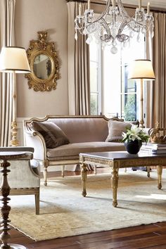 a living room filled with furniture and a chandelier