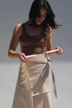 This wrap skirt features a layered knit design that flatters your figure and adds dimension to your ensemble. upgrade your wardrobe with this must-have piece for a touch of sophistication and charm.    details:    - 85% cotton 15% baby alpaca  - wash cold hang to dry  - made in peru    chéline is 5'9" bust 37" waist 25" hips 33" wearing size s    about the brand:    atelier delphine was born in march 2011 out of a desire to craft romantic loungewear for the modern woman. a life-long lover of beautiful things and meticulous workmanship designer yuka izutsu founded the range as a way to communicate a personal-aesthetic-collection by finding inspiration in both on-screen cinema sirens and the every-day bombshells that take it to bed. executed in muted colors and the highest quality fabrics de Romantic Loungewear, Born In March, Contemporary Clothes, Aesthetic Collection, Finding Inspiration, Tie Skirt, Personal Aesthetic, Blue Flats, Baby Alpaca