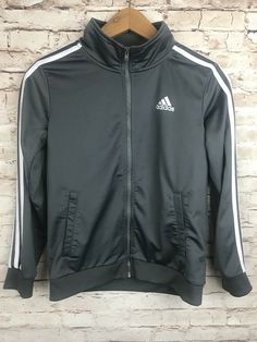 Youth Adidas Jogger Jacket.  Zip-up front jacket with pockets.  Gray with white stripes down sleeves.  Youth Medium 10-12 Gray Winter Long Sleeve Track Jacket, Adidas Stretch Long Sleeve Tops, Fall Sportswear Track Jacket Crew Neck, Solid-colored Sportswear Outerwear For Fall, Solid Sportswear Outerwear For Fall, Gray Long Sleeve Sportswear Outerwear, Gray Long Sleeve Track Jacket For Fall, Gray Long Sleeve Fall Track Jacket, Adidas Long Sleeve Track Jacket For Spring