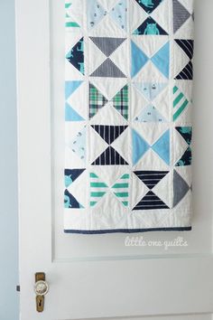 a white door with a blue and green quilt hanging on it