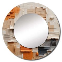 a round mirror with orange and white paint on it