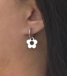 Earring size: 1.1'' x 0.6'' or 27mm x 15.2mm Hoop size: 16mm Flower size: 15.2mm Description: Simple and minimal daisy flower hoop earrings in gold or silver plated stainless steel. Stainless steel is a very durable and strong metal and is considered very high quality for jewelry. It has a very sleek appearance and is a good choice for casual and everyday wear.  Check out my shop for more items: https://www.etsy.com/shop/TenthRealmStudio Message me with any questions or concerns you may have, I' White Flower Hoop Earrings With Flower Charm, Minimalist Flower Shaped Pierced Jewelry, Everyday Flower Hoop Earrings, Everyday Flower Shaped Hoop Earrings, Small Hoop Jewelry With Flower Charm For Everyday, Everyday Small Hoop Jewelry With Flower Charm, Everyday Flower Charm Hoop Earrings, Dainty Hoop Earrings With Flower Charm, Hypoallergenic Flower-shaped Earrings For Everyday Wear