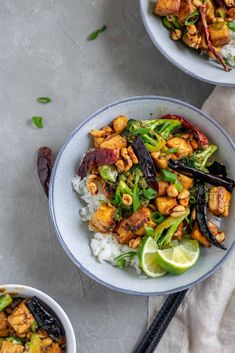 two bowls filled with chicken and vegetables on top of rice