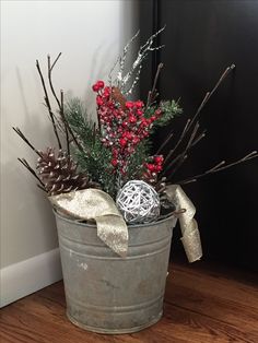 a bucket filled with christmas decorations on top of a wooden floor