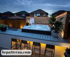 a hot tub sitting on top of a roof next to some chairs and potted plants