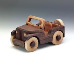 a wooden toy car is shown on a white background