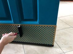 a person is opening the door with a small black object in it's hand