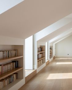 an empty room with bookshelves and wooden floors