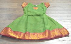 Your little one is sure to steal the show with this Green Sugandi Cotton Silk with zari lines all over the lehenga zari Maroon Red pattu border. It comes with a back rope tie to adjust the waist The yoke part is green in color with zari lines all over and pattu Maroon Red zari border sleeves to enhance the look of the gown Size  Dress Length: 29 inches (Shoulder to ankle/toes) Yoke Length: 9.5 inches (shoulder to above waist) Sleeves Length: 2.5 inches  Bust Size: 26 inches (round length - front Fitted Short Sleeve Dresses For Festivals, Short Sleeve Fitted Dresses For Festivals, Green Pallu Dress For Summer, Green Dress With Pallu For Summer, Green Summer Dress With Pallu, Traditional Fitted Full-length Dress, Fitted Self Design Dress For Festivals, Fitted Self-design Dress For Festivals, Fitted Dress With Self Design For Festivals