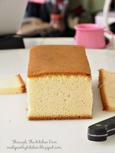 a piece of cake sitting on top of a white plate next to a pair of scissors