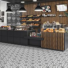 the interior of a bakery with black and white tiles