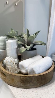 a wooden tray with towels and other items on it