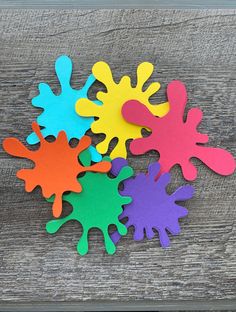 colorful paint splattered on top of a wooden table