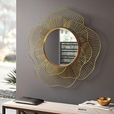 a mirror that is on the wall above a table