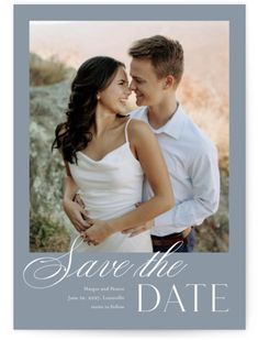 the save the date photo card is shown in grey and features an image of a couple embracing