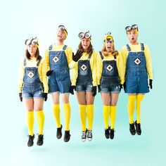 five people in overalls and yellow socks are posing for a photo with their mouths open