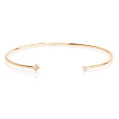 14k gold open cuff bracelet with a white prong set white diamond on one end of the cuff and a bezel set princess diamond on the other end SPECIFICS • cuff wire is approx. 1.5mm wide• total bracelet is approx. 6.4cm wide x 5cm tall• cuff opening is approx. 28mm• white diamonds .11ctw Hexagon Bangle, Diamond Evil Eye Bracelet, Diamond Bar Bracelet, Lily Bracelet, Safety Pin Bracelet, Solitaire Bracelet, Nameplate Bracelet, Multi Chain Bracelet, Eternity Bracelet