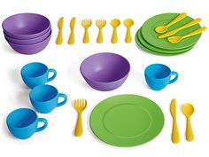 a set of children's plastic dinnerware including plates, cups and spoons