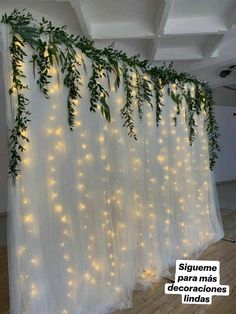 the curtain is decorated with lights and greenery