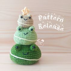 a crocheted frog with a hat on its head sitting on top of a rock