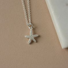 Sterling Silver Starfish Necklace - Beachy Necklace for Women -  Ocean Inspired Summer Jewelry This necklace has a delightful ocean-inspired theme that's perfect for summer. It features a charming sterling silver starfish charm with intricate detailing and a realistic texture down to the dotted pattern. The charm is one-sided (the back view is shown in the second-to-last image) and it measures 13mm wide and 16mm long (excluding the loop). The charm slides freely along sterling silver rolo chain, Cheap Silver Beaded Necklaces For Beach, Summer Starfish Charm Star Necklace, Starfish-shaped Necklace With Starfish Charm For Summer, Summer Star Charm Necklace As Gift, Summer Star Charm Necklace Gift, Summer Gift Necklace With Star Charm, Summer Gift Necklaces With Star Charm, Ocean-inspired Necklaces With Star Charm, Star-shaped Ocean-inspired Necklaces For Beach