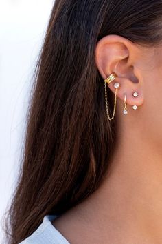 The Amara are stud earrings with a dangling chain and conch ear cuffs. These modern, outstanding, minimalist-style earrings can be worn daily as well as on special occasions. Perfect for a gift! Features: * Stud size: 4 x 4 mm. * Ear cuff inner diameter: 11 mm. * Ear cuff width: 5 mm. * Chain length: 6 mm. * They are sold in singles and pairs. Both options are available on the dropdown menu. * All of our jewelry is made of sterling silver (925 mm), and our gold jewelry is gold plated in 18K gold Dangle Ear Cuff With Matching Earrings For Everyday, Everyday Dangle Ear Cuff With Matching Earrings, Dainty Dangle Ear Cuff, Gold Plated Dangle Ear Cuff With Matching Earrings, Dainty Dangle Ear Cuff For Pierced Ears, Elegant Dangle Cartilage Earrings With Adjustable Chain, Minimalist Dangle Ear Cuff With Matching Earrings, Elegant Dangle Piercings With Adjustable Chain, 2nd Piercing