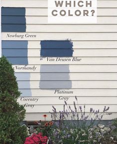 the side of a house with different shades of blue paint on it and flowers in front