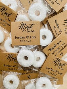 wedding donuts are wrapped in brown paper and labeled with the names of their guests