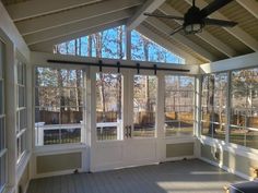 an enclosed porch with sliding glass doors