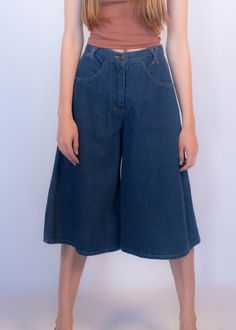 "Vintage 70s boho denim culottes. These great culottes are trending this season and are just perfect for summer style! High-waist fit. X criss-cross belt loops. Front pockets. Back western yoke detail. Wide-leg silhouette. Front button and zipper fastening. Unlined. Cut from 100% cotton. We kindly ask that you please view all measurements for comparison so you can get your desired fit. * Brand: n/a * Decade: 1970s * Fabric: 100% Cotton * Lining: Unlined * Color: Medium Dark Wash C O N D I T I O Spring Wide Leg Flare Jeans With Belt Loops, Spring Wide-leg Flare Jeans With Belt Loops, Retro High Waist Flare Jeans For Spring, 70s Inspired Wide Leg Jeans For Spring, High Waist Flare Jeans With Belt Loops For Spring, Retro Wide Leg Jeans For Summer, Spring Cropped Leg Flare Jeans, 70s Inspired Denim Jeans For Spring, Wide Leg Cropped Jeans With Belt Loops For Spring