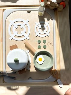 a wooden table topped with pots and pans